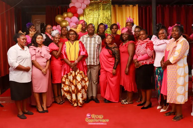 Women dressed in pink and red gather for a group photograph at the WOID@5 Dinner Night.