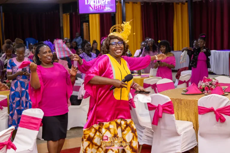 Women in pink dance and celebrate together at the WOID@5 Dinner Night.
