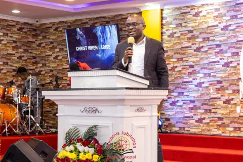 Rev. Arnold Omurwa speaks at a pulpit.